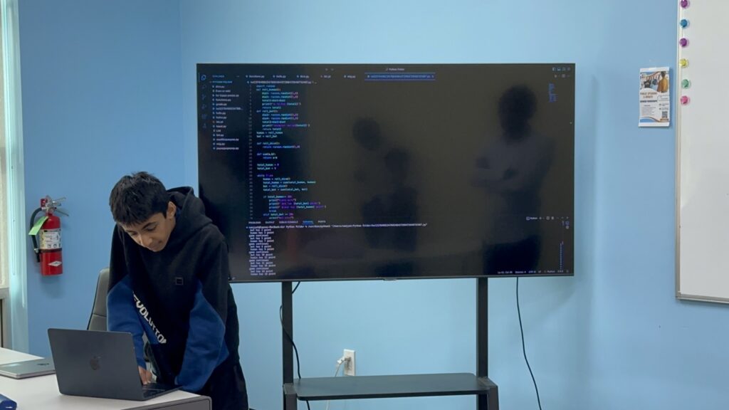 Students participating in Python summer camp activities at Y2L Academy.